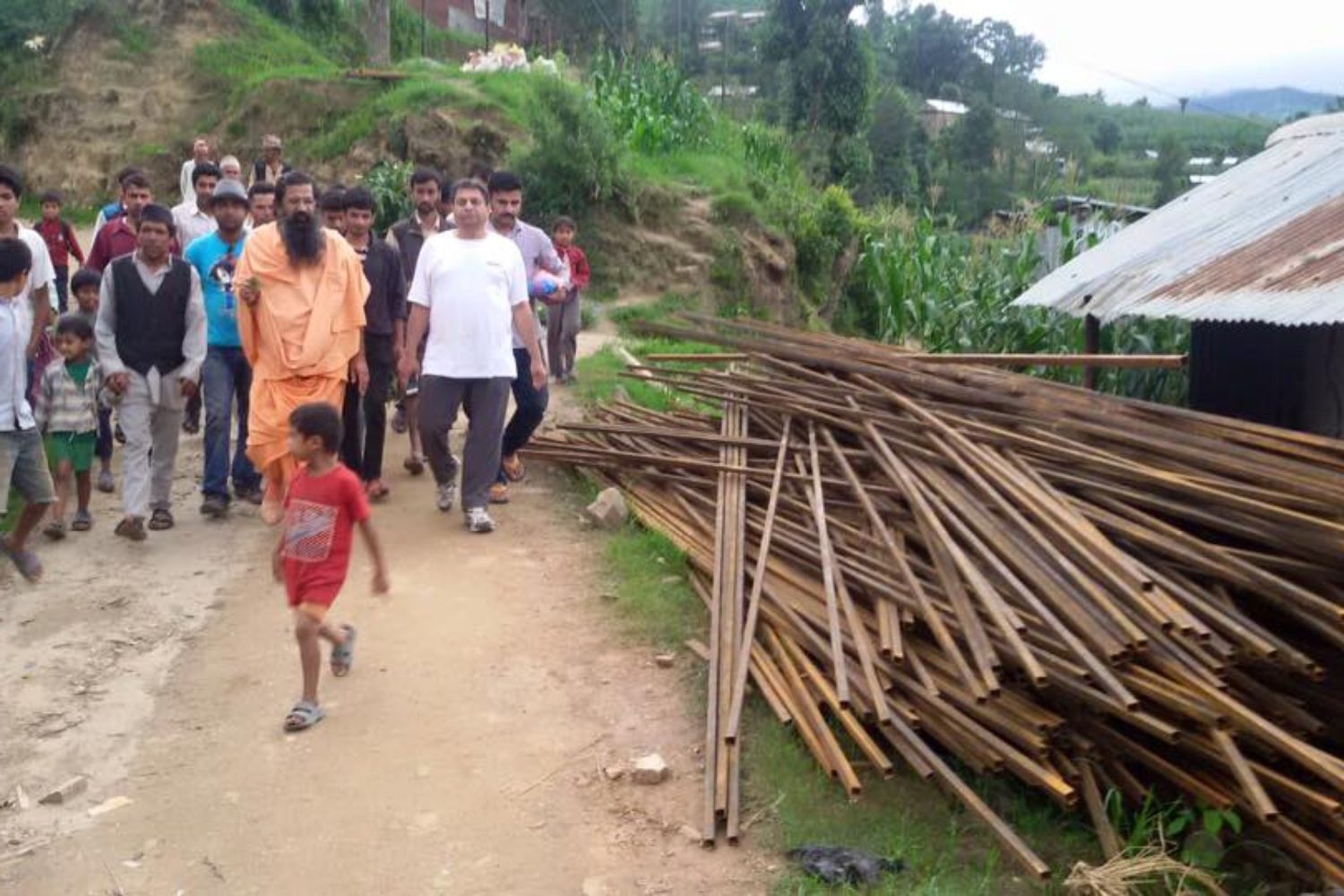 Group of Indian people walking on a dirt road