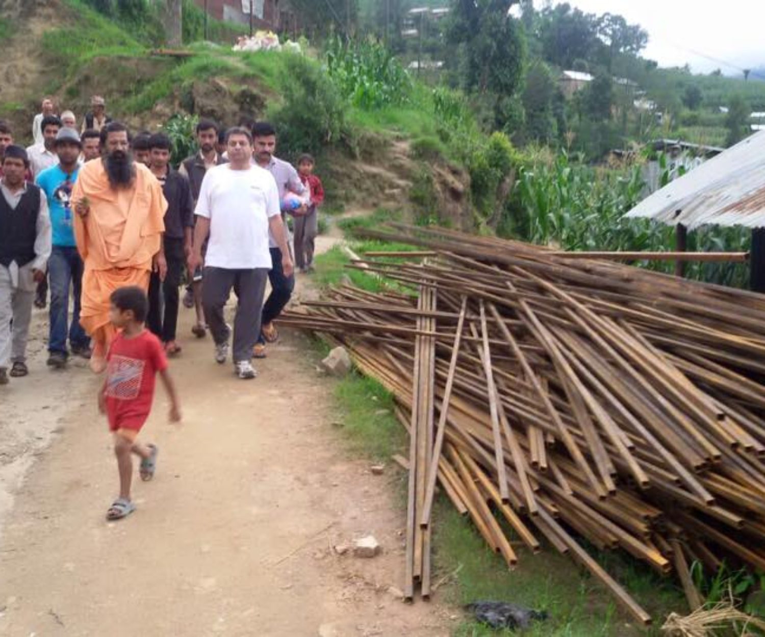 Group of Indian people walking on a dirt road
