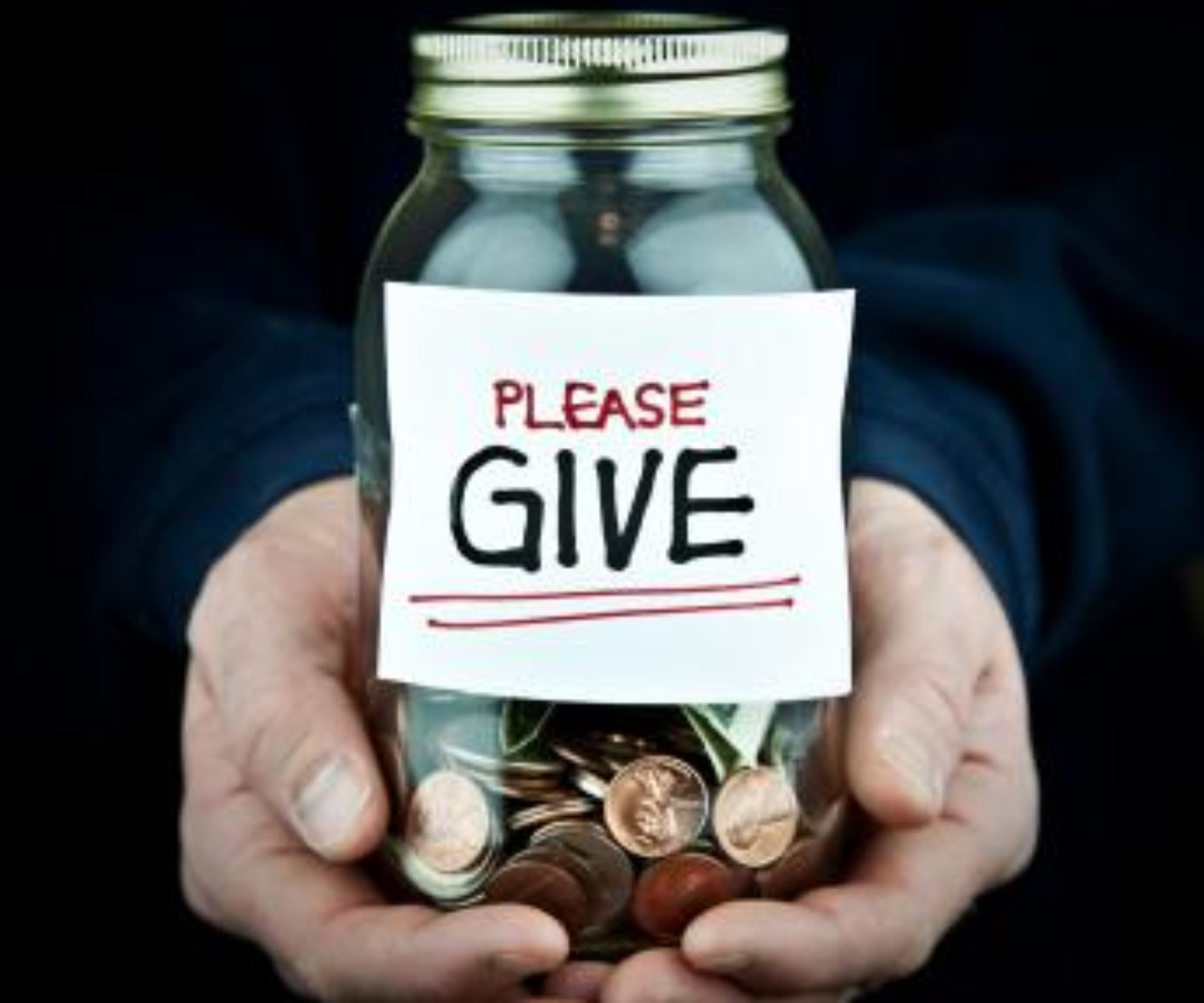Hands holding a jar of change with a Please Give sign